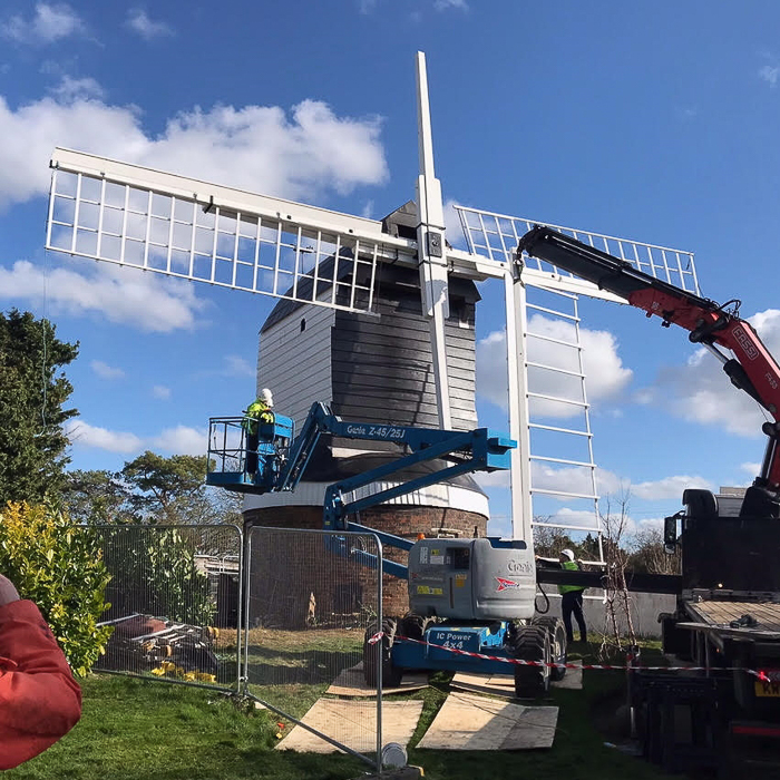 Windmill being replaced using a crane