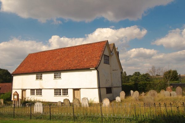 A lime washed grade 2 listed chapel with red tile roof