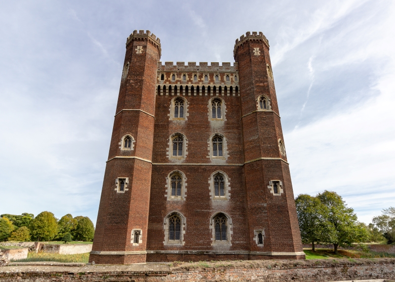  A photo of a tall, thin castle in red brick. 
