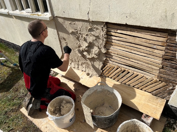 A SPAB Scholar plastering the wall of the chapel