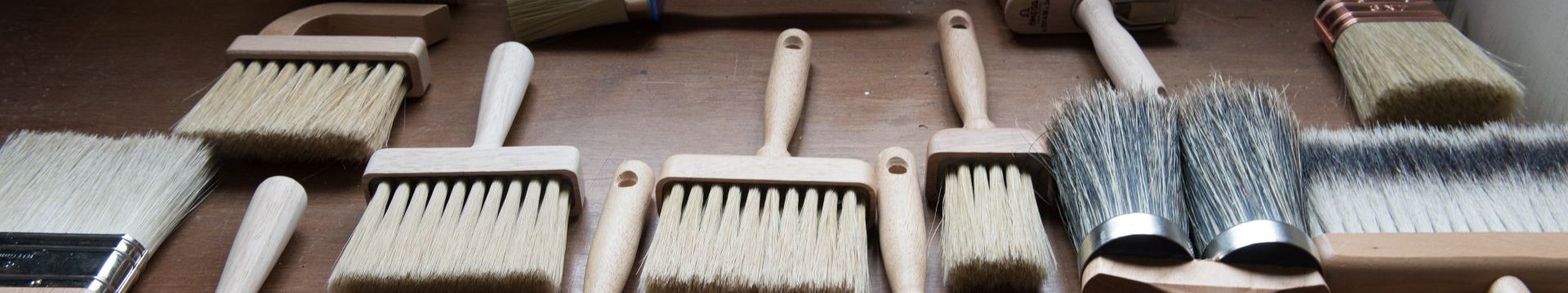 Brushes and tools for traditional paintwork laid on a table at the Rose of Jericho factory
