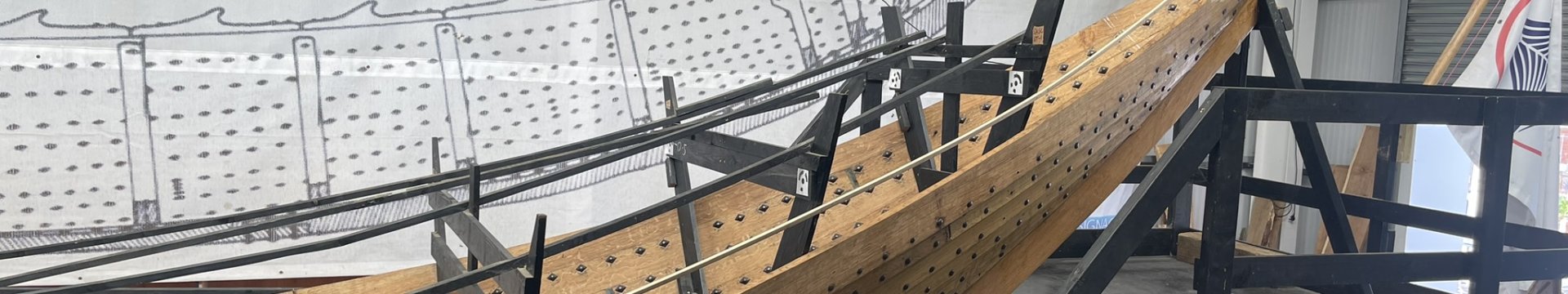 A partial view of the Sutton Hoo replica longship in the boat shed