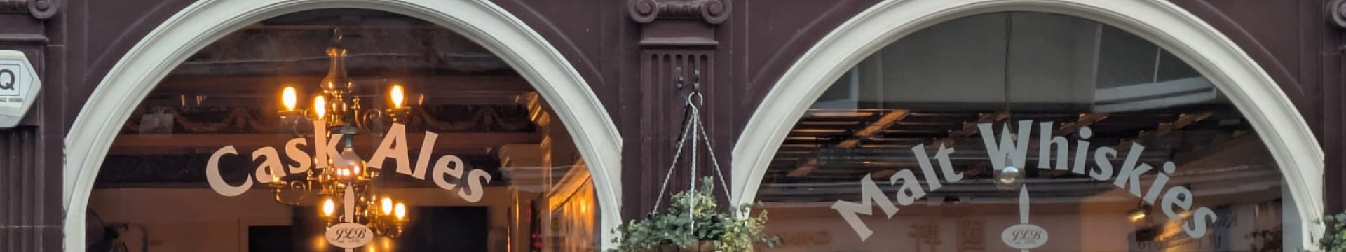 Exterior archways and sign of the John Leslie Pub