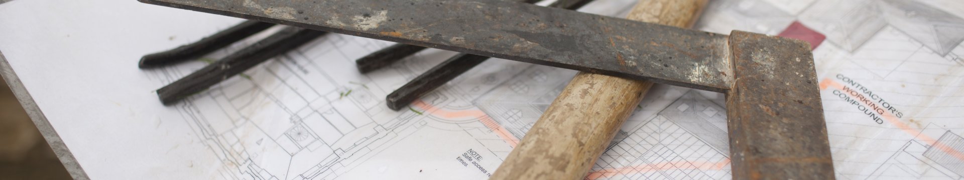 Metal tools on top of architectural plan.