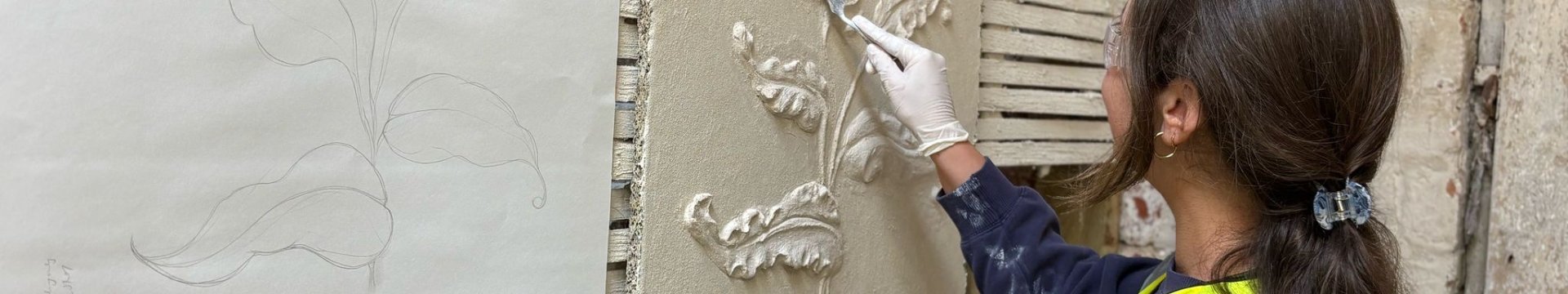 A woman using a hand tool to create a pargeted panel. 