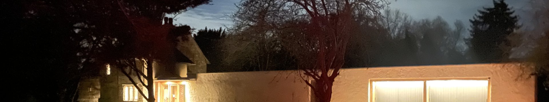 St Andrews Chapel at night. With the house and walkway lit up.