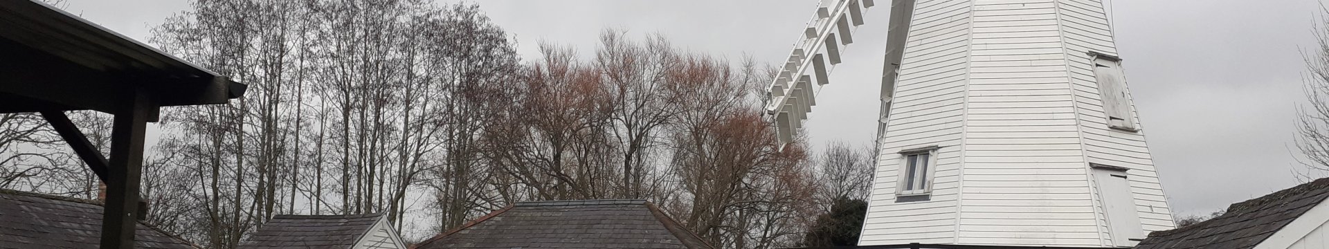 A white windmill in its setting.