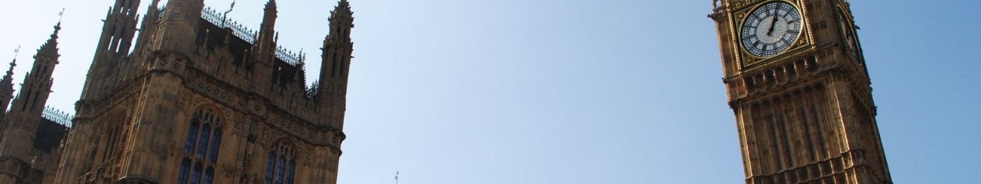 The houses of parliament against a blue sky with the clock tower.