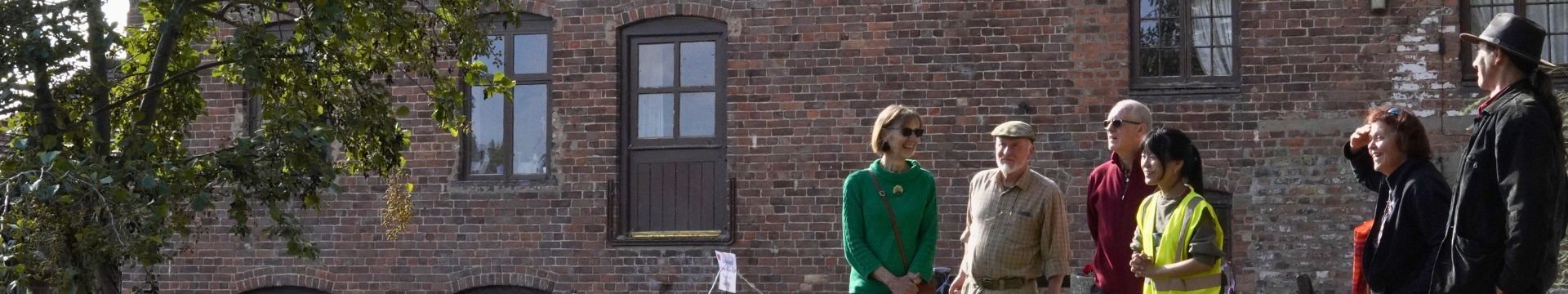 People stood in front of Fladbury Mill for a tour.