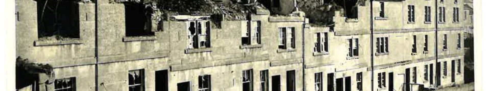 A row of ruined terraced houses. Sepia print