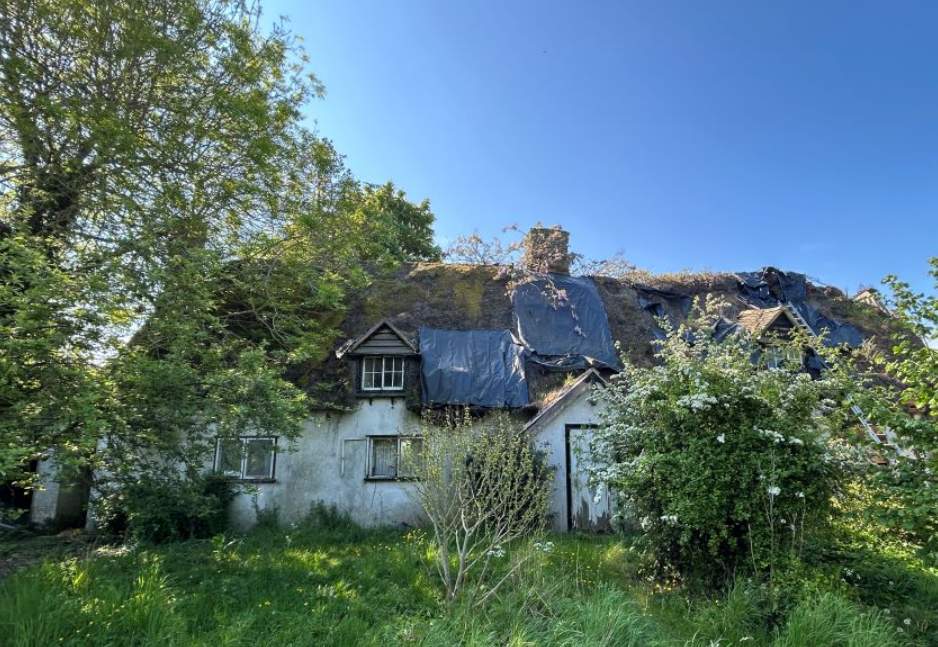 dilapidated thatched cottage