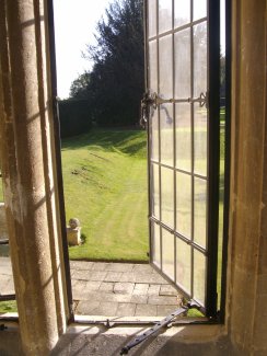 Leaded window opening to a garden