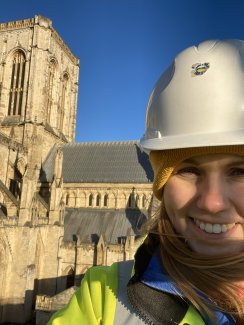 A woman in a hard hat in front of York Minster Cathedral