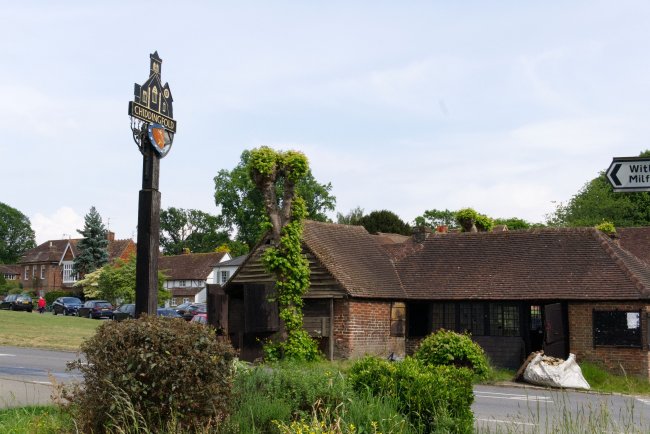 Chiddingfold forge. Old building and village sign