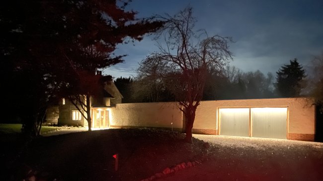 St Andrews Chapel at night. With the house and walkway lit up.