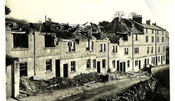 A row of ruined terraced houses. Sepia print